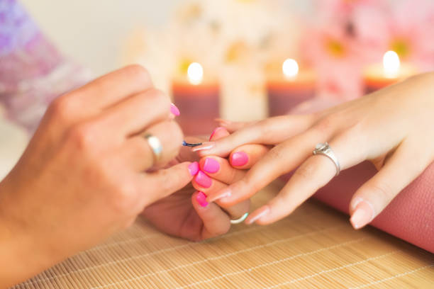 Manicure process in a professional beauty salon Manicure process in a professional beauty salon, making of artificial nails. artificial nail stock pictures, royalty-free photos & images