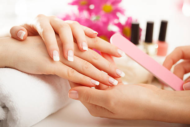Manicure treatment Female having manicure. nail salon stock pictures, royalty-free photos & images