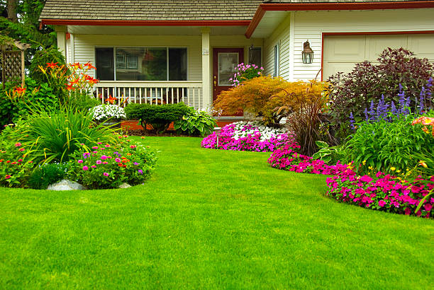 Manicured House and Garden Manicured House and Garden displaying annual and perennial gardens in full bloom. lawn stock pictures, royalty-free photos & images