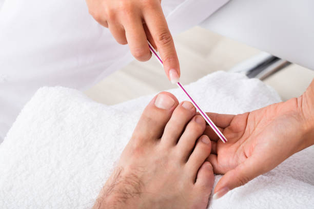Manicurist Doing Pedicure Close-up Photo Of A Manicurist Doing Pedicure man pedicure stock pictures, royalty-free photos & images