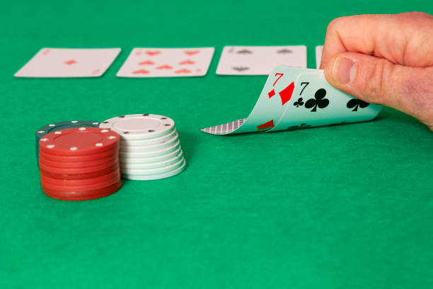 A man's hand playing poker stock photo