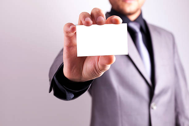 Man's hand showing business card stock photo