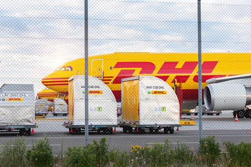 Schkeuditz, Germany - 29th May, 2022 - Many big cargo planes parked on Leipzig Halle airport terminal tarmac apron for loading, service maintenance. DHL air mail express fast logistic hub terminal.