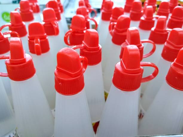 many bottles of glue neatly arranged in the supermarket. stock photo