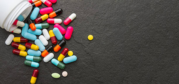 Many pills and tablets on black background. Many pills and tablets on black background for decorate and design project. capsule medicine stock pictures, royalty-free photos & images