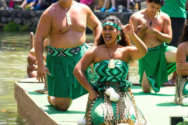 Maori Performers on a canoe float at the Polynesian Cultural Center, a popular tourist attraction of Oahu. stock photo