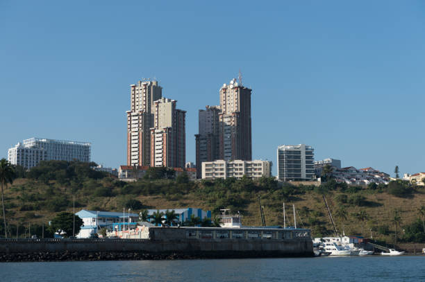Maputo skyline with harbour in foreground Tall buildings in the Mozambican capital Maputo, as seen from across Maputo Bay. Ships in the harbour, foreground. maputo city stock pictures, royalty-free photos & images