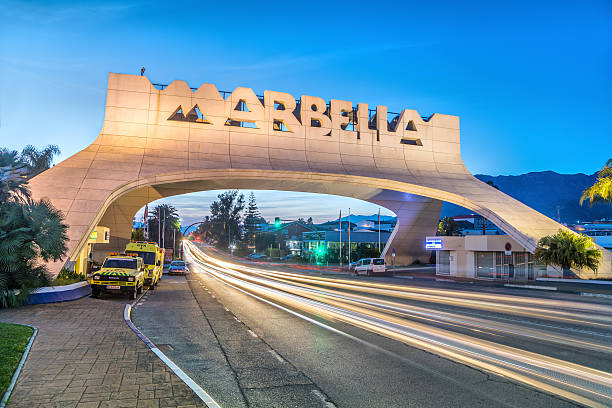 Marbella Entrance Arch at dusk Marbella, Spain - December 26 2016: Marbella Entrance Arch at dusk marbella stock pictures, royalty-free photos & images