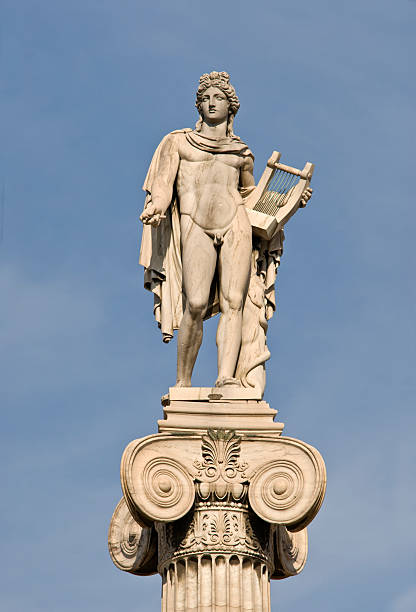 marble-apollo-statue-against-blue-sky-picture-id179312324