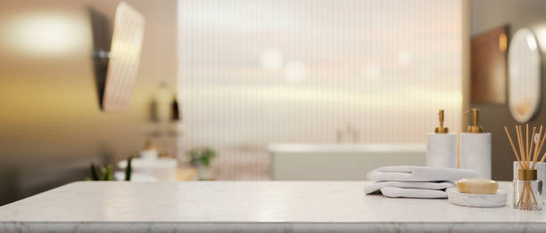 Marble tabletop with toiletry and mockup space over blurred elegance bathroom interior stock photo