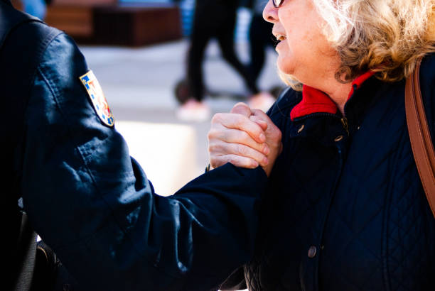March for education. Strike. Civilian woman and policeman handshake stock photo