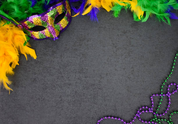 mardi gras carnival mask, feather boa and beads over blackboard background - carnival accessories flat lay imagens e fotografias de stock