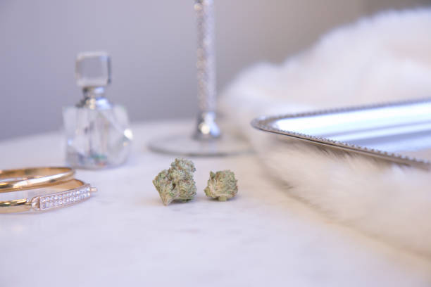 Marijuana Buds on Marble Vanity with Jewelry and Perfume Luxury Cannabis stock photo