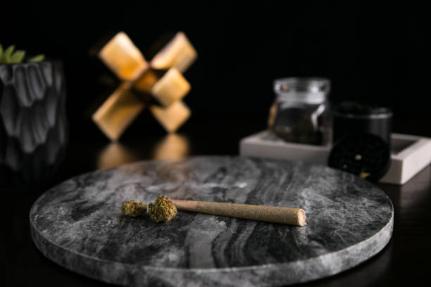 Marijuana Joint and Buds on Dark Marble Luxury Cannabis stock photo