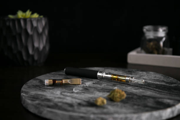 Marijuana Vape Pen, Concentrate and Buds on Dark Background Luxury Cannabis stock photo