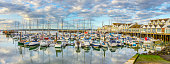 istock Marina and harbor in Southampton, UK, with tranquil waters reflecting clouds, sky. 1182975677