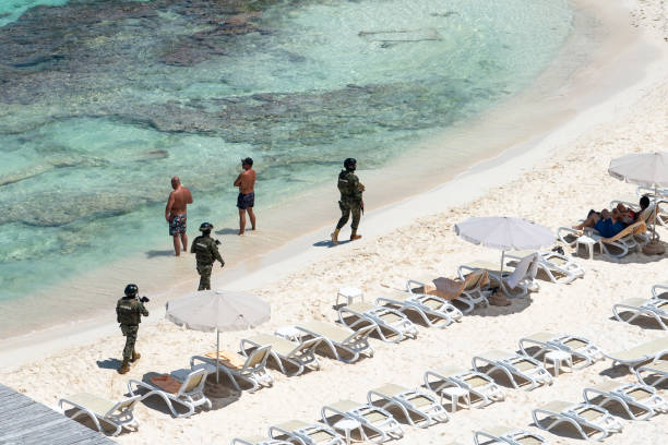 Cancun, Mexico - September 15, 2021. Marina soldiers of Mexican army patrolling beach in Cancun stock photo