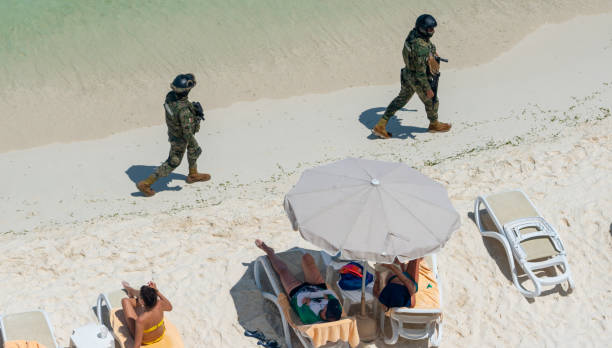 Cancun, Mexico - September 15, 2021. Marina soldiers of Mexican army patrolling beach in Cancun stock photo