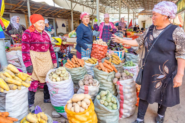 Market in Osh Kyrgyzstan Women vendors sell produce at the market in Osh, Kyrgyzstan. central asia stock pictures, royalty-free photos & images