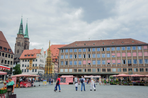 Nuremberg, Germany - August 8, 2012: Hauptmartk in Nuremberg. This is central square in Nuremberg with world famous Schoner Brunnen and Frauenkirche. There is street market with residents and tourists during the day.