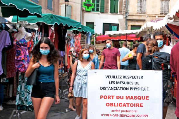 Market with people wearing mask to prevent Coronavirus French market with people wearing mask to prevent Covid 19 virus, during pandemic 2020, in Florac, (Occitanie) France - August 13, 2020. cevennes national park stock pictures, royalty-free photos & images