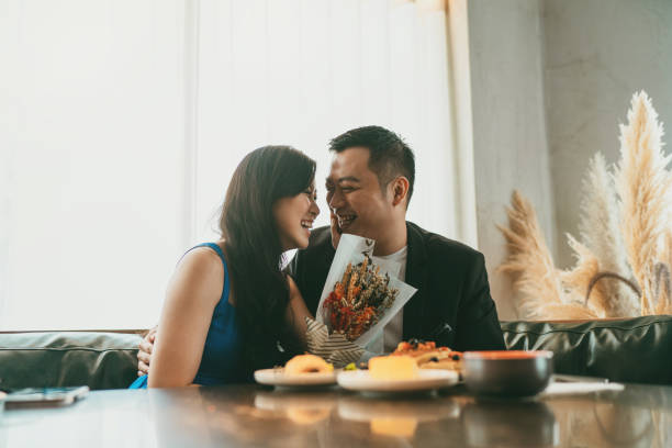 Married Asian couple dining and enjoying their conversations stock photo