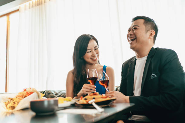 Married Asian couple dining and enjoying their conversations stock photo