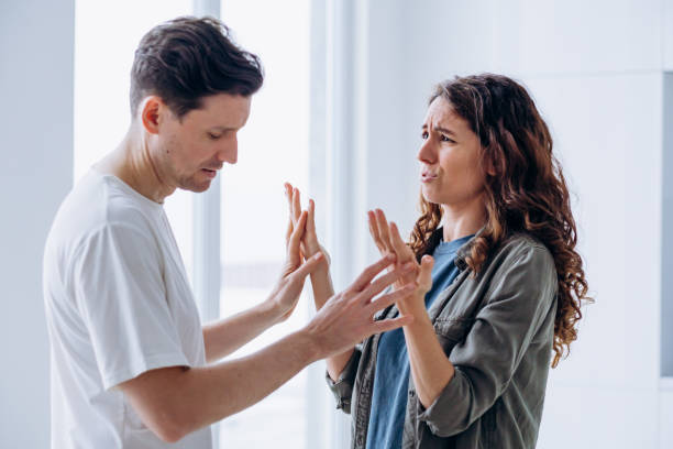 Married woman and man quarrel over family problems gesturing stock photo