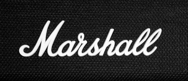 Marshall logo on guitar amplifier Manchester, UK - July 20, 2011: Marshall logo on a guitar amplfier. Marshall Amplification is a British company, founded by drummer Jim Marshall in 1962, that designs and manufactures music amplifiers. Their guitar amplifiers are among the most recognized brands in popular music. marshall photos stock pictures, royalty-free photos & images