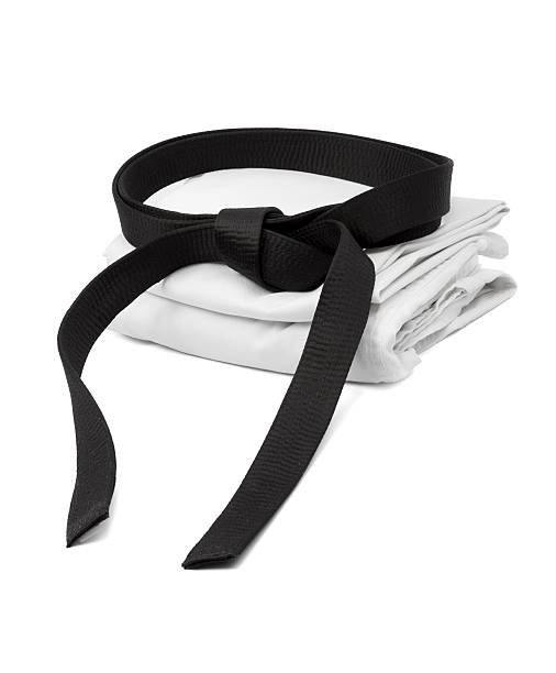 Martial arts uniform with black belt in white background Martial arts black belt and kimono karate stock pictures, royalty-free photos & images