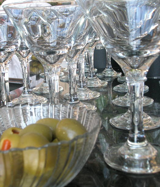 Martini Glassware at Bar with Olives dirty martini stock pictures, royalty-free photos & images