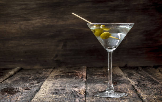 Martini with olives. Martini with olives. On a wooden background. vermouth stock pictures, royalty-free photos & images