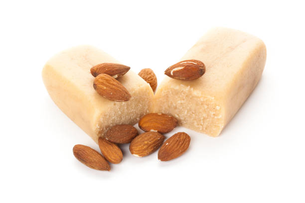 Marzipan block and almonds isolated stock photo