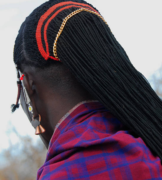 Masai warrior hair decoration.The earlobe is elongated and decorated. rear view of  hair decoration of an adult Masai warrior.The earlobe is elongated and decorated,Ngorongoro Conservationa Area,Tanzania. maasai warrior stock pictures, royalty-free photos & images