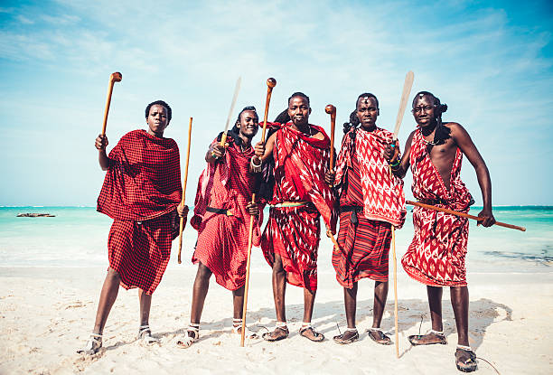 Masai Warriors Masai warriors in traditional clothing demonstrating their weapons on the beach (Zanzibar, Africa). masai warrior stock pictures, royalty-free photos & images