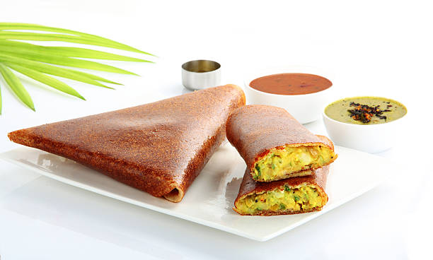 Masala dosa from south India Masala Dosa is made by stuffing by a dosa with lightly cooked filling of potatoes, fried onions and spices. This can be served with chutney and sambar. This can be eaten for breakfast. thosai stock pictures, royalty-free photos & images
