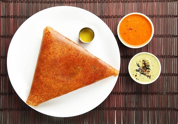 Masala sin Masala dosa with different types of chutney and sambar. This is a closeup shot of one of the most famous indian snack. thosai stock pictures, royalty-free photos & images