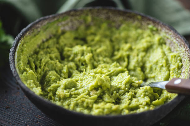 Mashed avocado in a bowl stock photo