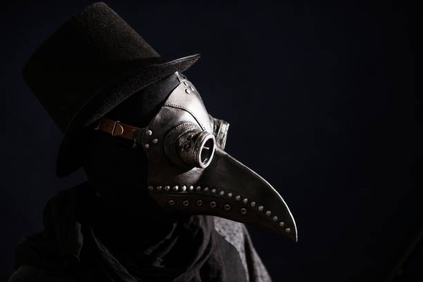 Masked man plague doctor, head profile, with bird mask and hat. Vintage style. Biohazard concept. Masked man plague doctor, head profile, with bird mask and hat. Vintage style. Biohazard concept. bubonic plague photos stock pictures, royalty-free photos & images