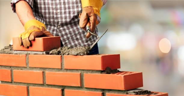 Masonry. Worker builds a brick wall bricklayer stock pictures, royalty-free photos & images