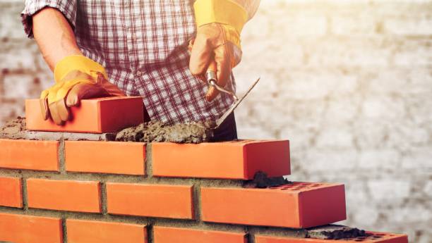 Masonry. Worker builds a brick wall in the house bricklayer stock pictures, royalty-free photos & images