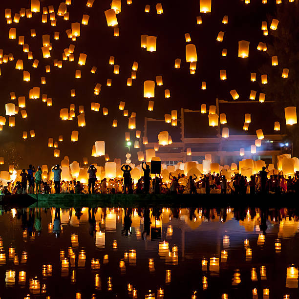 Mass Sky Lantern Release People release sky lanterns to pay homage to the triple gem: Budhha, Dharma and Sangha during Yi Peng festival. chinese lantern festival stock pictures, royalty-free photos & images
