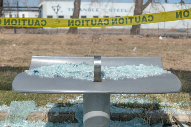 Mass transit bus stop with smashed glass on chair stock photo