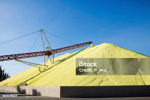 istock Massive mound of industrial sulfur at worksite 183419517