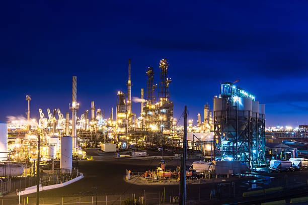 Massive Oil Refinery Lit Up at Night California oil refinery steaming and glowing at night. Still taken from time lapse video #545977644. oil refinery stock pictures, royalty-free photos & images