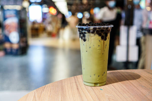 Matcha Green tea Bubble drinks. A plastic cup of matcha green tea topped with brown sugar bubble or boba or tapioca pearls. Boba Matcha Latte stock pictures, royalty-free photos & images