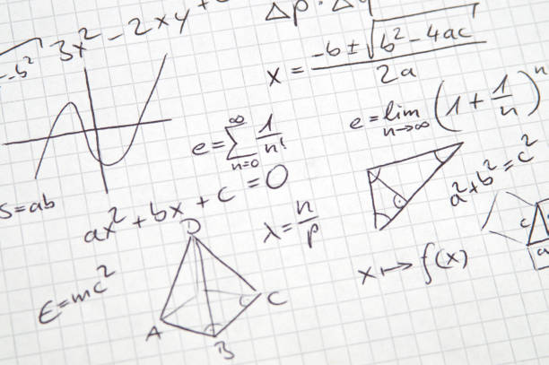 Math notes in handwriting on checkered paper stock photo