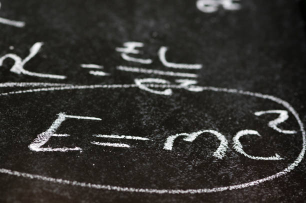Mathematical derivation of E=mc^2 on a blackboard Mathematical derivation of E=mc^2 on a blackboard albert einstein stock pictures, royalty-free photos & images