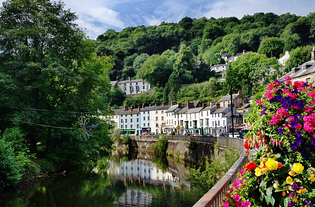 Matlock Bath and River Derwent View of the River Derwent flowing through Matlock Bath in Derbyshire with trees and flowers derbyshire stock pictures, royalty-free photos & images