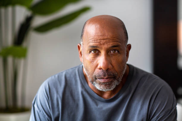Mature African American man with a serious look on his face. Portrait of a mature man not smiling looking the camera. sad old black man stock pictures, royalty-free photos & images